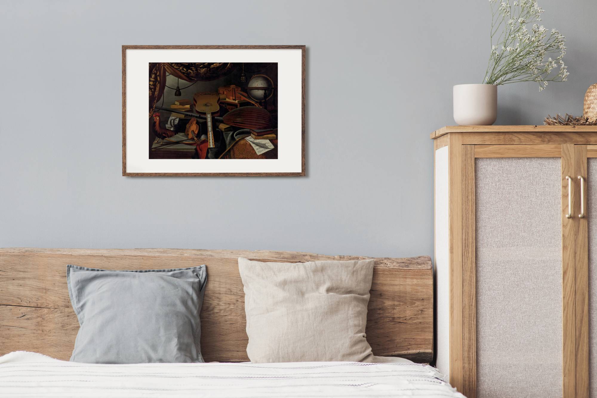 Musical instruments, books, music scores, a globe and a rooster on a table draped with a carpet